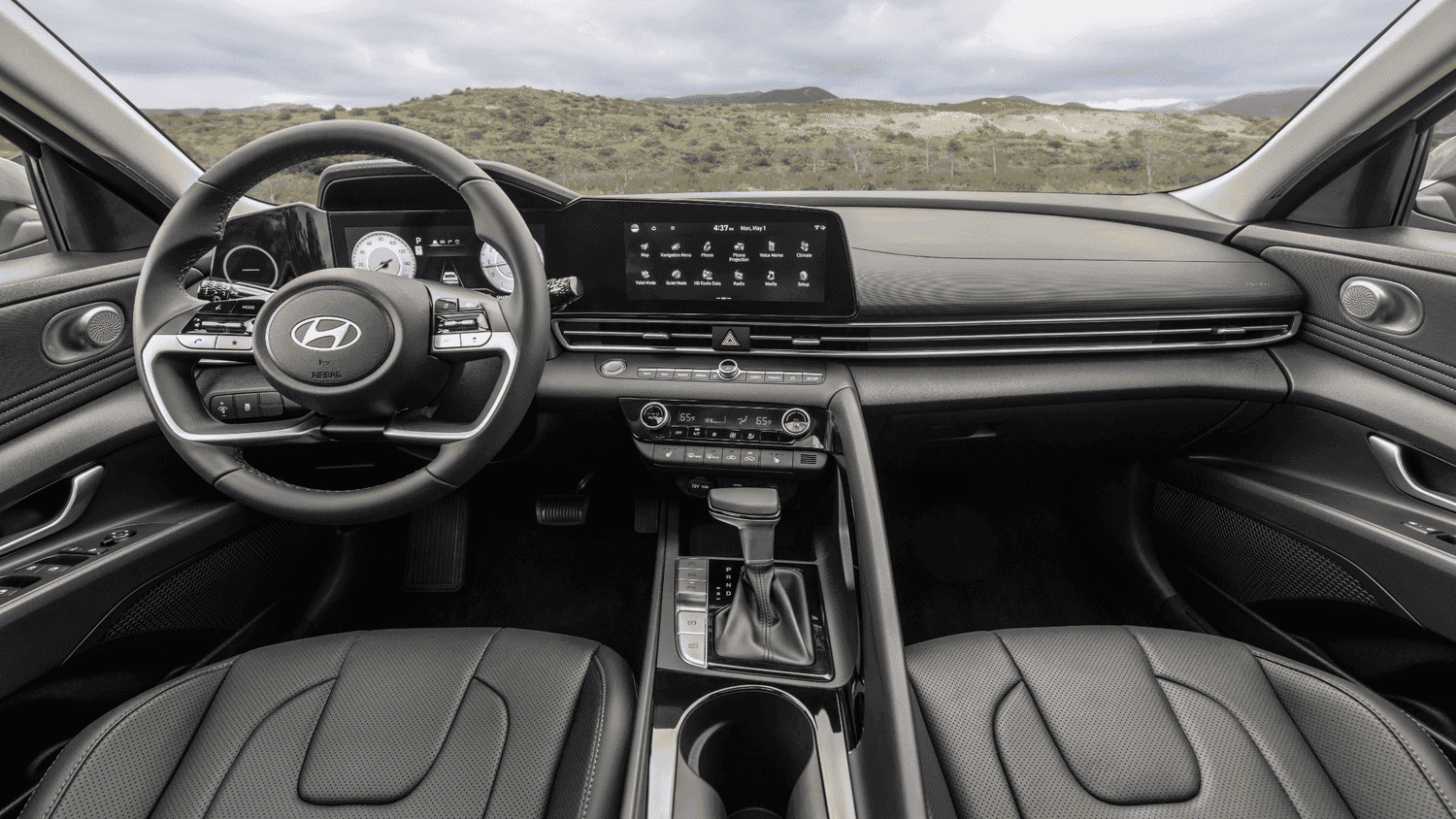 Interior dashboard of the 2025 Hyundai Elantra in Athens, GA, highlighting its intuitive controls and digital display layout against a scenic mountain backdrop.