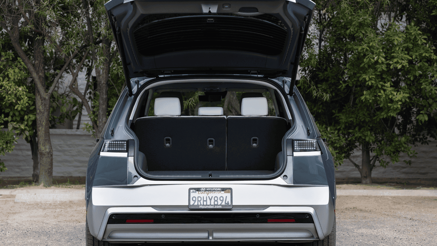 Open rear hatch of the 2025 Hyundai IONIQ 5 in Athens, GA, showing off the EV’s practical cargo space and fold-flat rear seats.