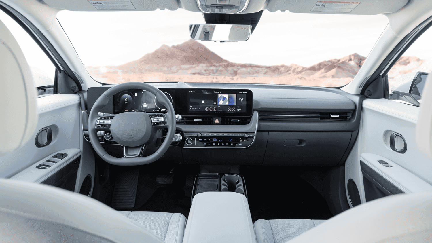 Driver’s view of the 2025 Hyundai IONIQ 5 near Loganville, GA, featuring a digital instrument cluster and intuitive EV controls.