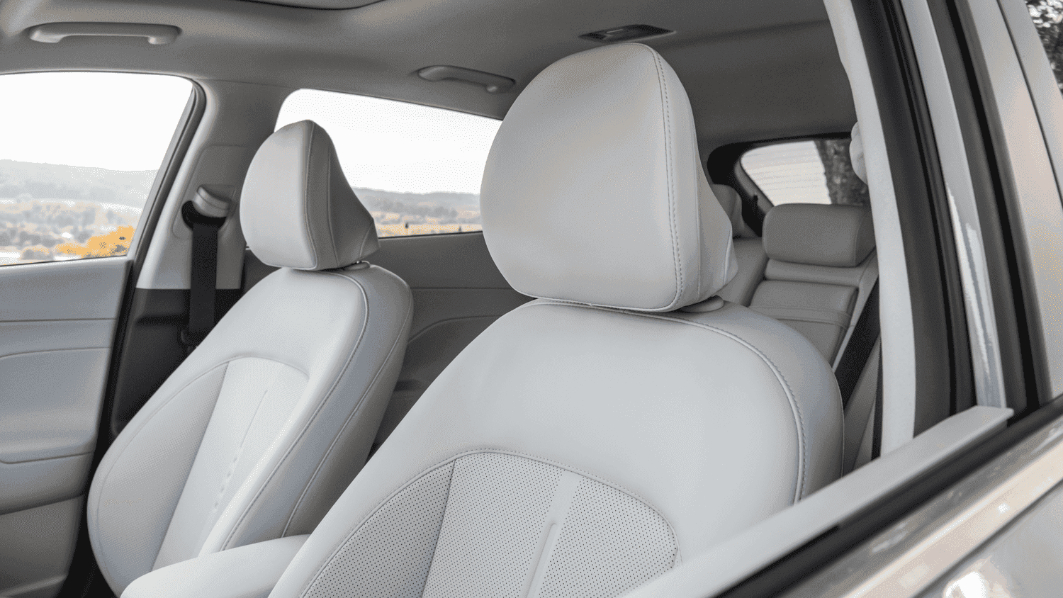 Close-up of the front seats in the 2025 Hyundai Kona, highlighting the light gray leather upholstery and comfort-focused design for Athens, GA drivers.