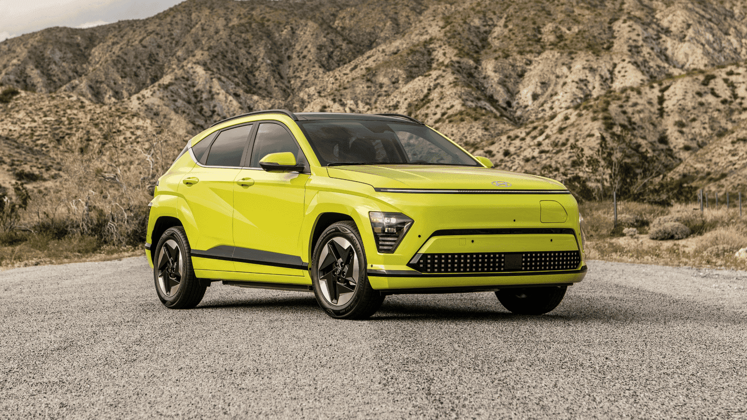 Bold green exterior of the 2025 Hyundai Kona Electric standing out in a mountain landscape near Athens, GA.