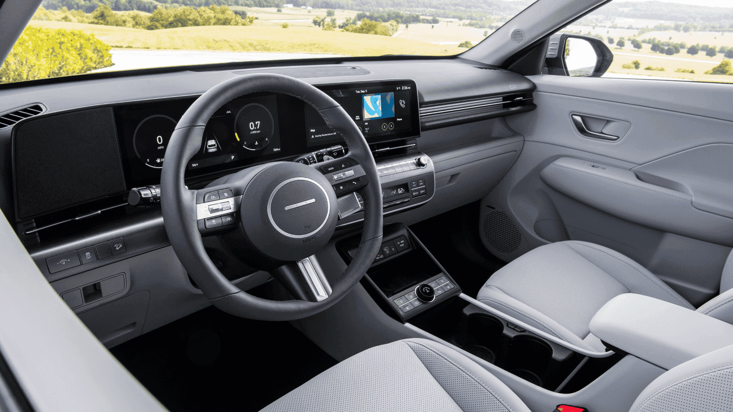 Rear seat view of the 2025 Hyundai Kona near Loganville, GA, showcasing its spacious and comfortable passenger area with light-colored upholstery.