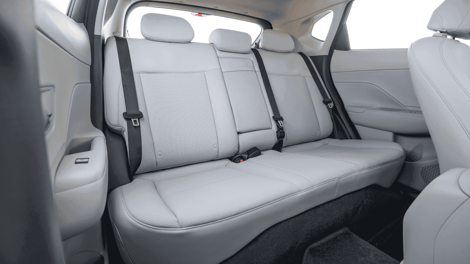 Rear seat view of the 2025 Hyundai Kona near Loganville, GA, showcasing its spacious and comfortable passenger area with light-colored upholstery.