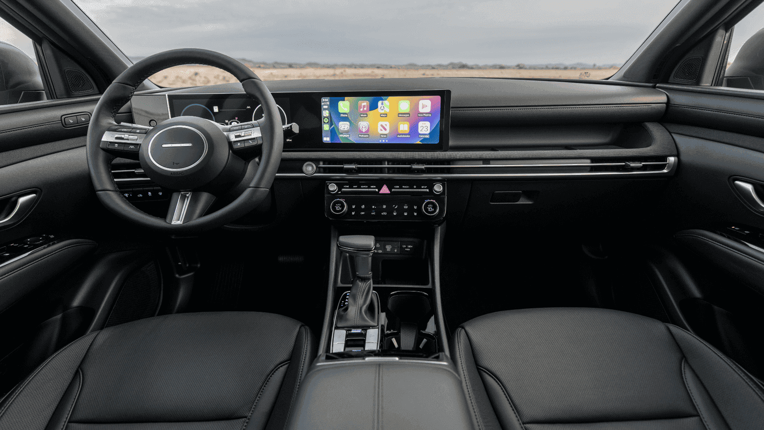 Front cabin of the 2025 Hyundai Santa Fe near Loganville, GA, highlighting luxury finishes and intuitive tech features.