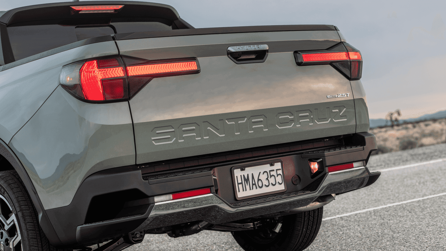 Rear view of the 2025 Hyundai Santa Cruz near Loganville, GA, showing the truck bed and bold tailgate lettering.