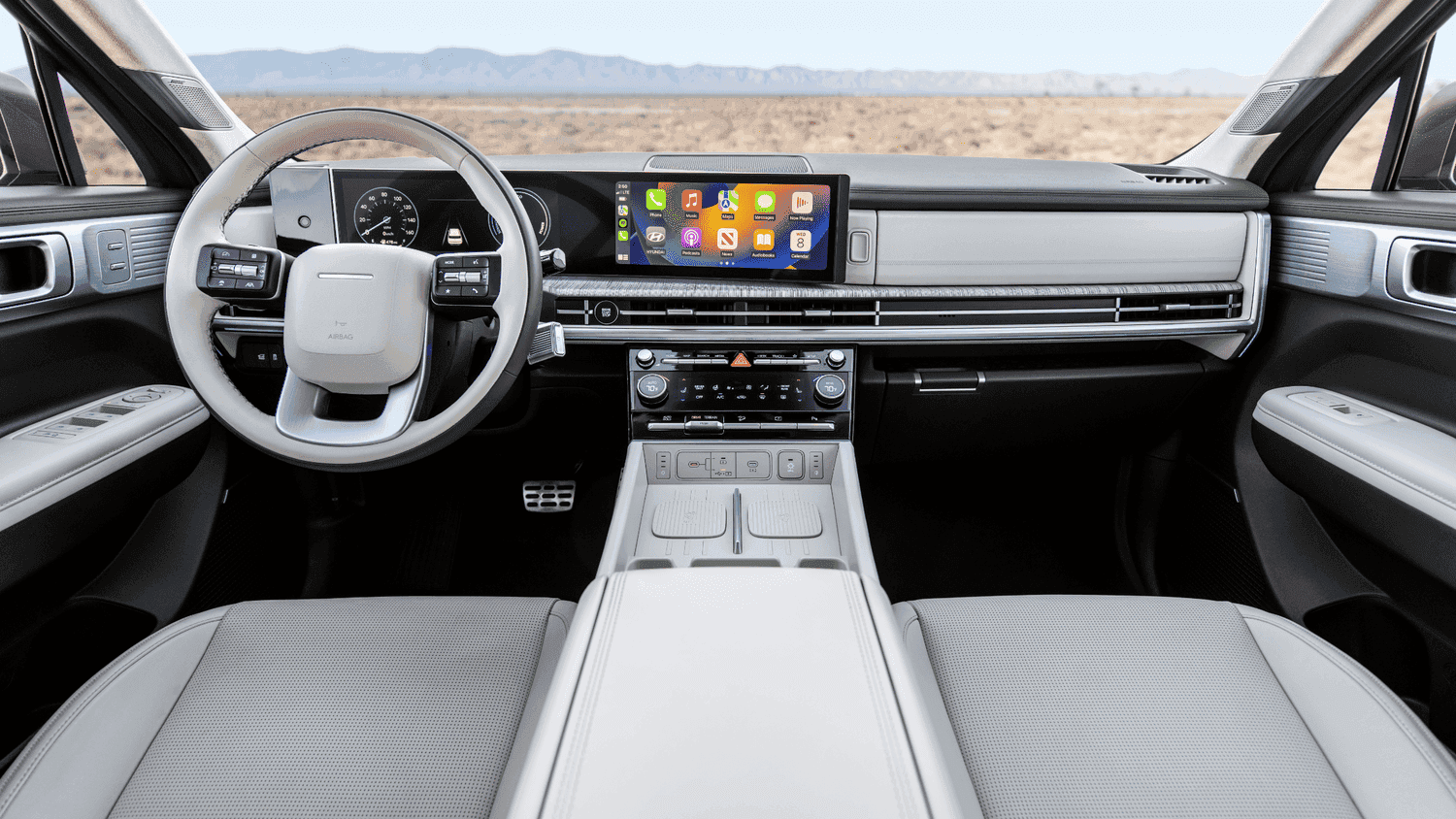  Interior view of the 2025 Hyundai Santa Fe Hybrid cabin with wide infotainment screen and sleek design, perfect for drivers in Athens, GA