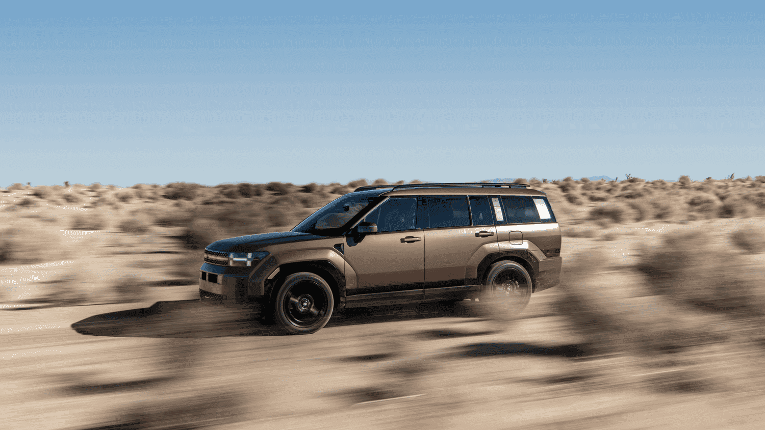  Front view of the 2025 Hyundai Santa Fe Hybrid driving through the desert, showcasing its rugged off-road capabilities near Athens, GA