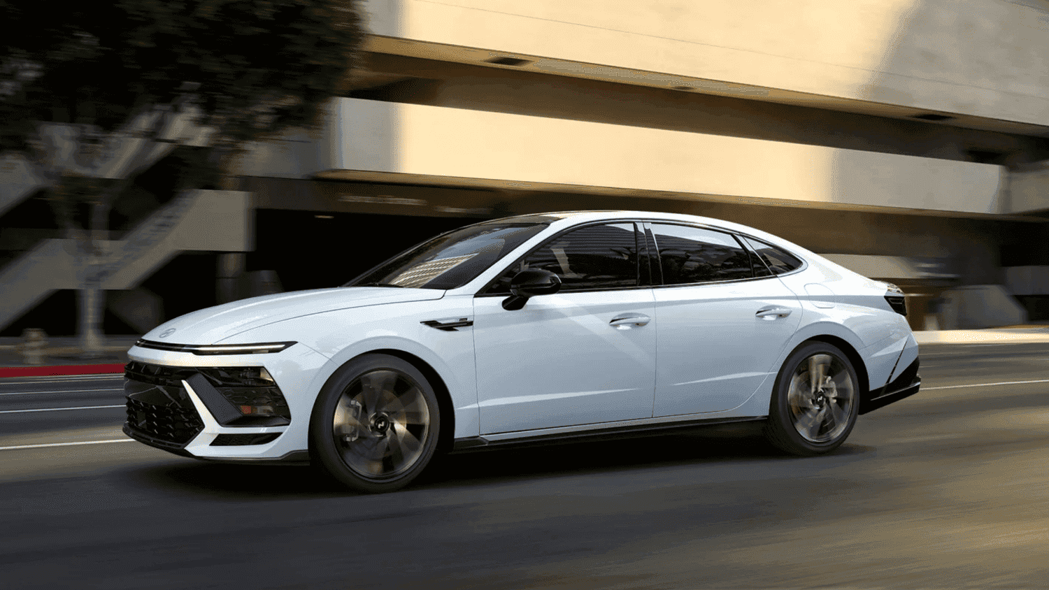 2025 Hyundai Sonata sedan cruising through downtown Athens, GA, showcasing aerodynamic styling.