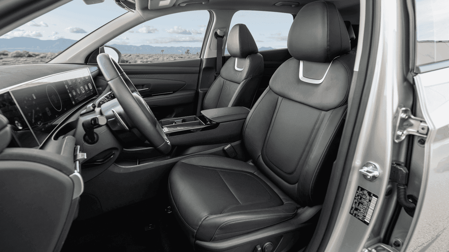 Front passenger view of the 2025 Hyundai Tucson Plug-in Hybrid showcasing its premium leather seats and sleek dashboard design in Athens, GA.