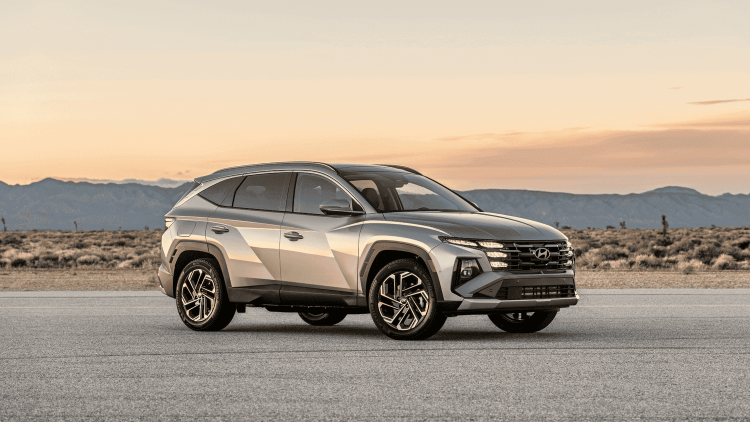Side profile of the 2025 Hyundai Tucson Plug-in Hybrid parked at sunset, highlighting its modern exterior styling and alloy wheels in Athens, GA