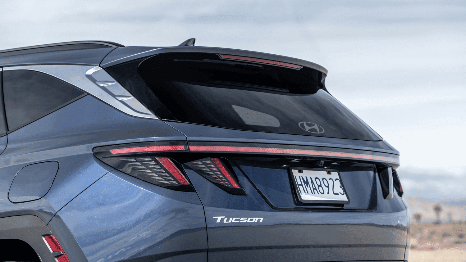 Rear design of the 2025 Hyundai Tucson near Loganville, GA, showcasing its stylish LED taillights and distinctive SUV profile.