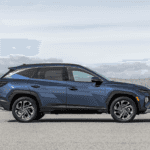 2025 Hyundai Tucson SUV parked in a scenic area near Loganville, GA, highlighting its modern profile and spacious design.