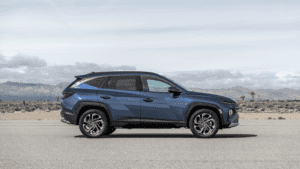 2025 Hyundai Tucson SUV parked in a scenic area near Loganville, GA, highlighting its modern profile and spacious design.