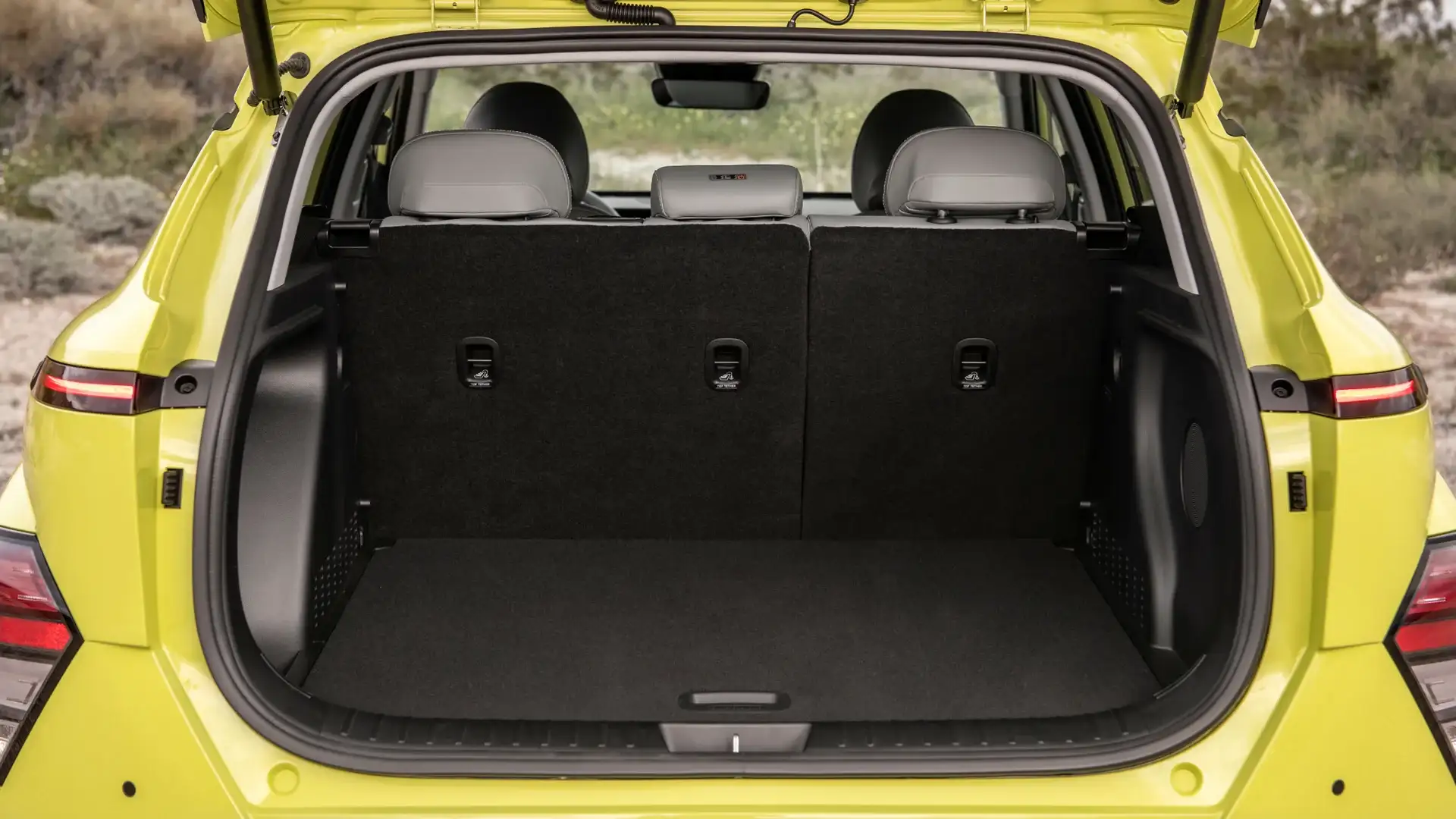 2026 Hyundai Kona Electric rear cargo space with split-fold seats and wide trunk opening.