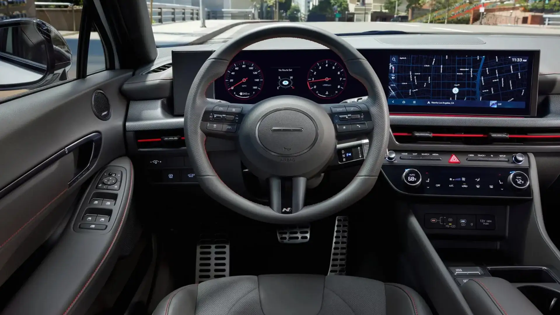 2026 Hyundai Sonata interior with sport steering wheel, digital cluster, and navigation display.