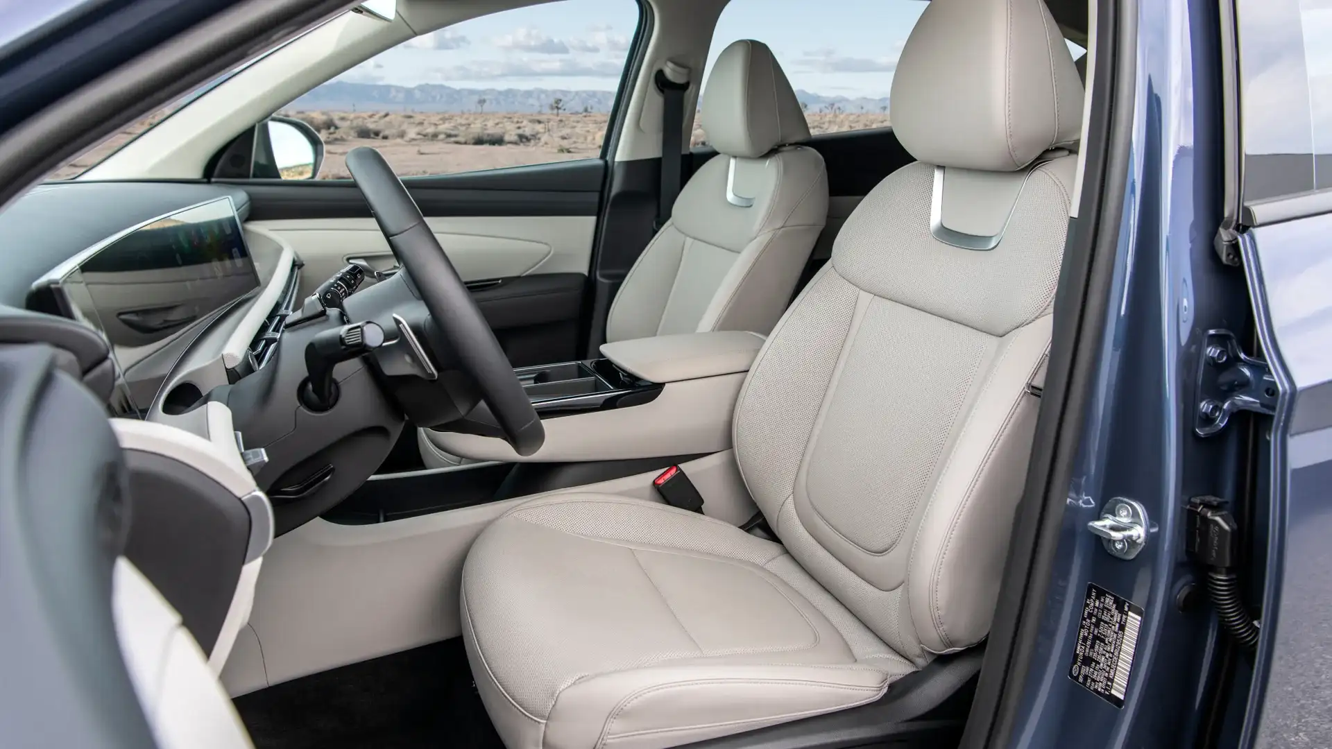 2026 Hyundai Tucson interior with beige leather seats, digital display, and sleek dashboard.