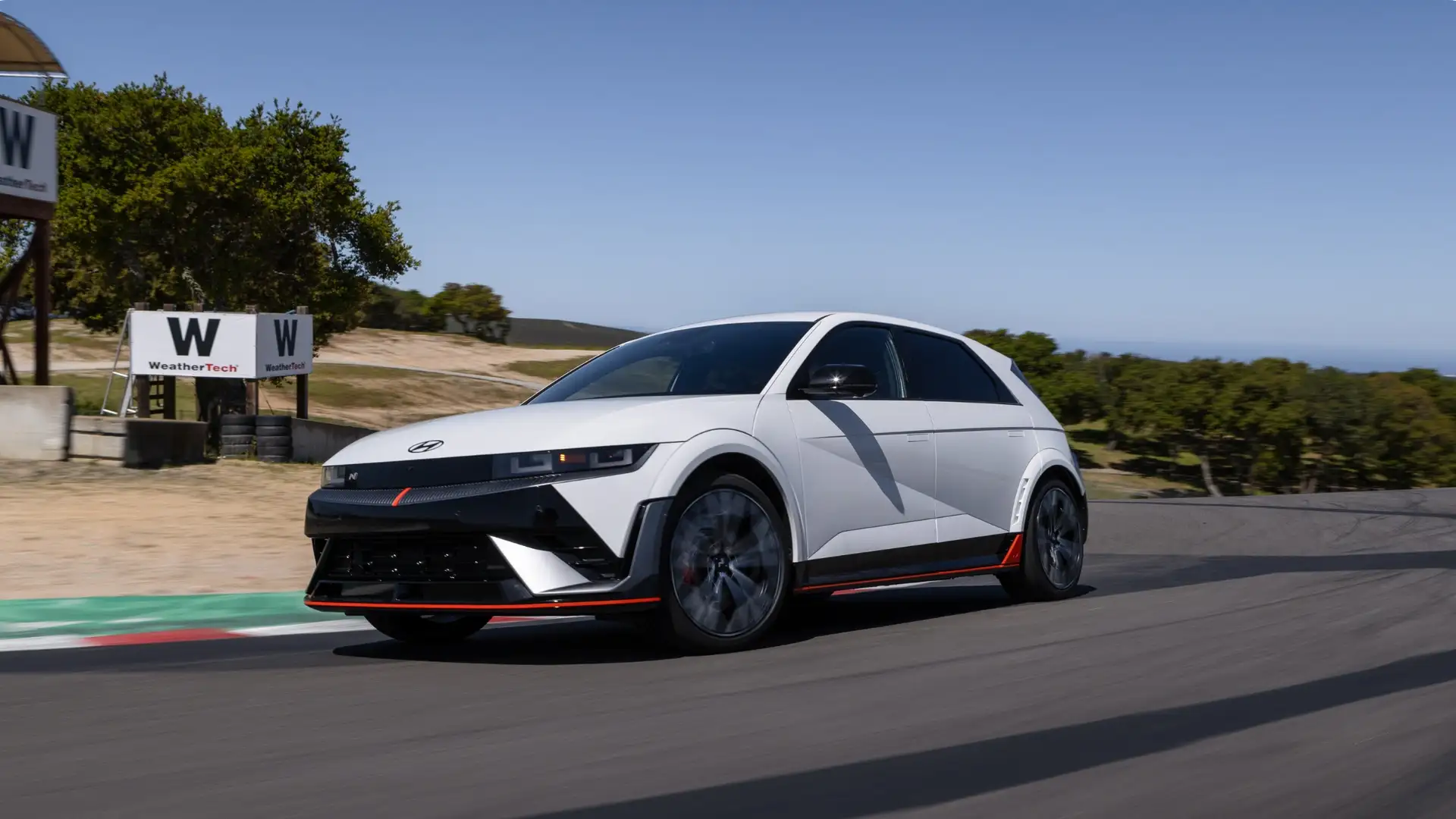 2025 Hyundai IONIQ 5 N electric performance SUV driving on a racetrack showcasing sporty design and aerodynamics.