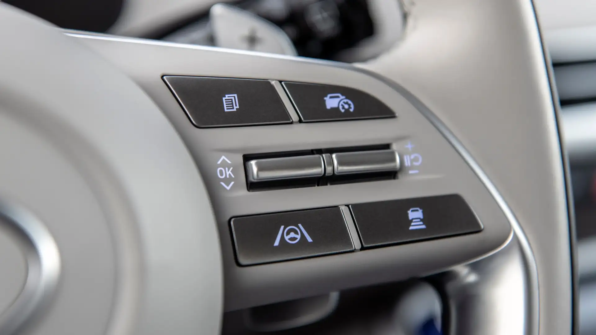 Close-up of the 2025 Hyundai Palisade steering wheel controls displaying adaptive cruise control, lane-keeping assist, and driver assistance buttons for convenience.