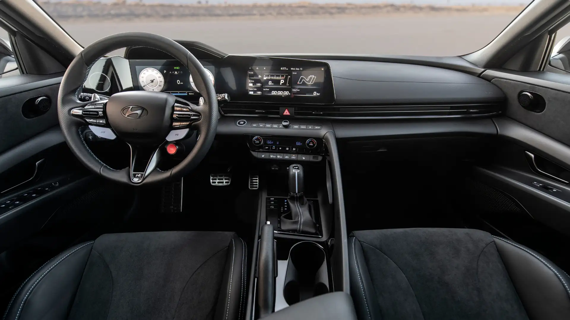 Driver’s cockpit view of the 2026 Hyundai Elantra N showcasing its digital display, N performance steering wheel, and sporty interior layout.