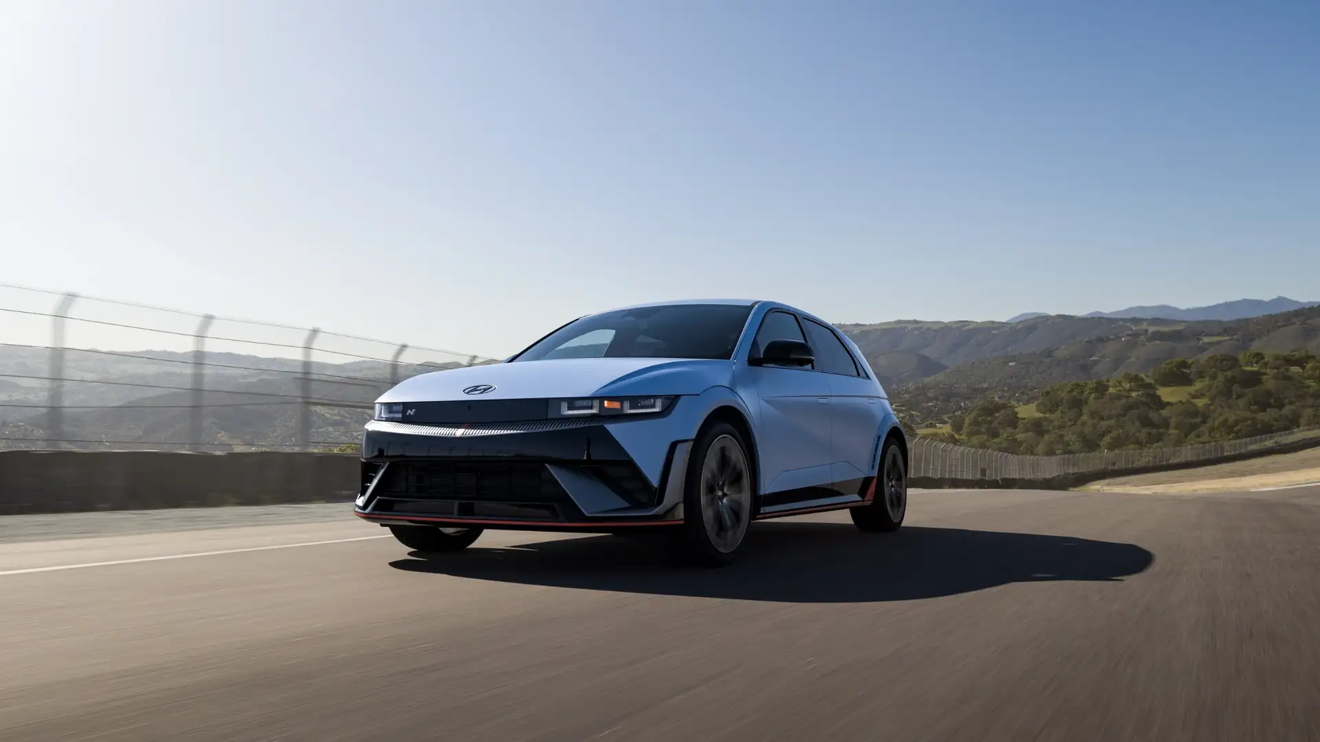 2026 Hyundai IONIQ 5 N electric performance crossover speeding on a race track highlighting advanced EV technology.