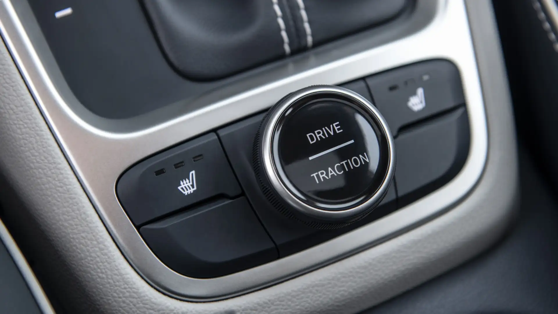 Close-up view of the 2026 Hyundai Venue center console showing the drive mode selector dial and heated seat controls for enhanced comfort and traction.