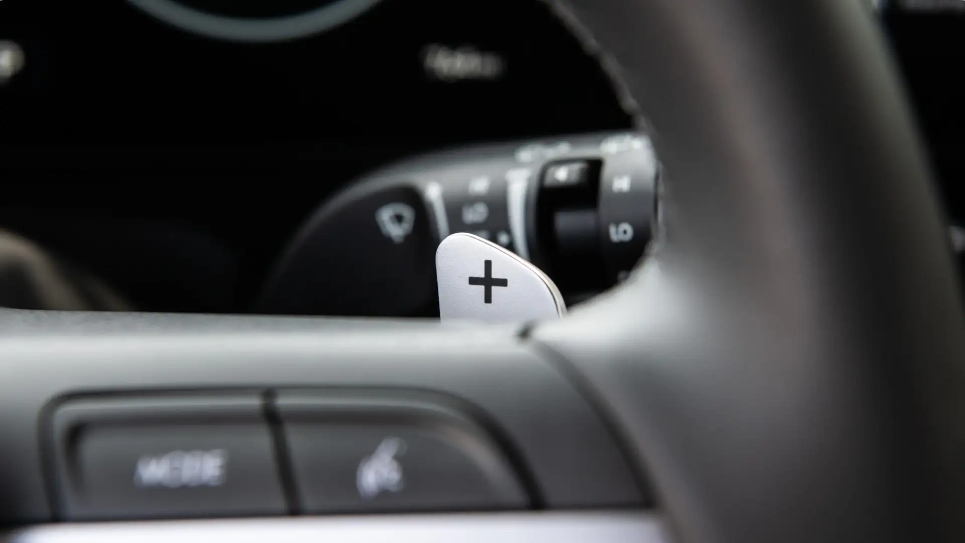 2025 Hyundai Kona close-up of steering wheel paddle shifter with plus indicator.