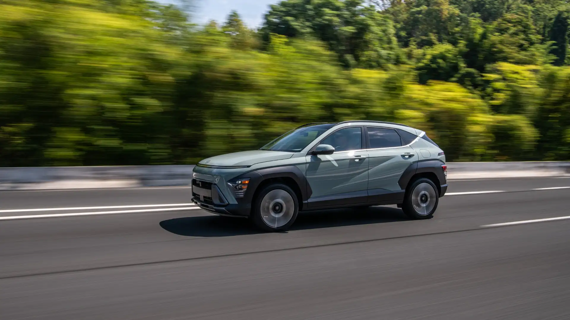 2025 Hyundai Kona in motion on highway with sleek aerodynamic profile and distinctive front lighting.