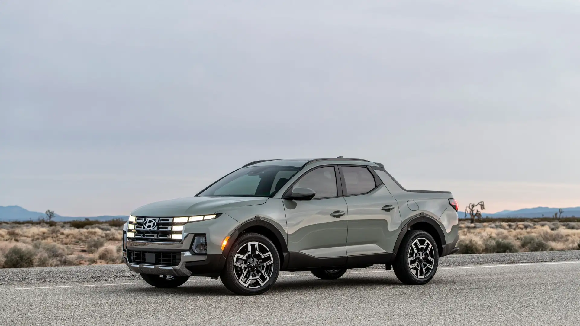 2025 Hyundai Santa Cruz shown in side-angle view on open road with bold front grille design.