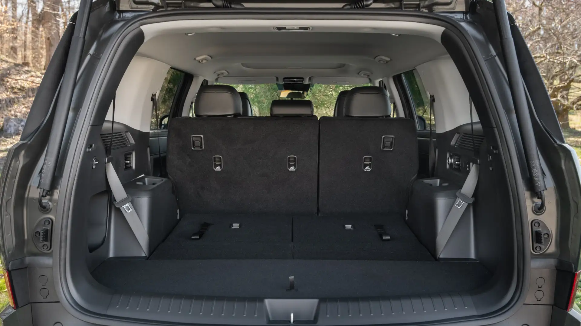 Cargo area of a 2026 Hyundai Santa Fe with third-row seats upright, showing spacious rear storage and clean interior layout.