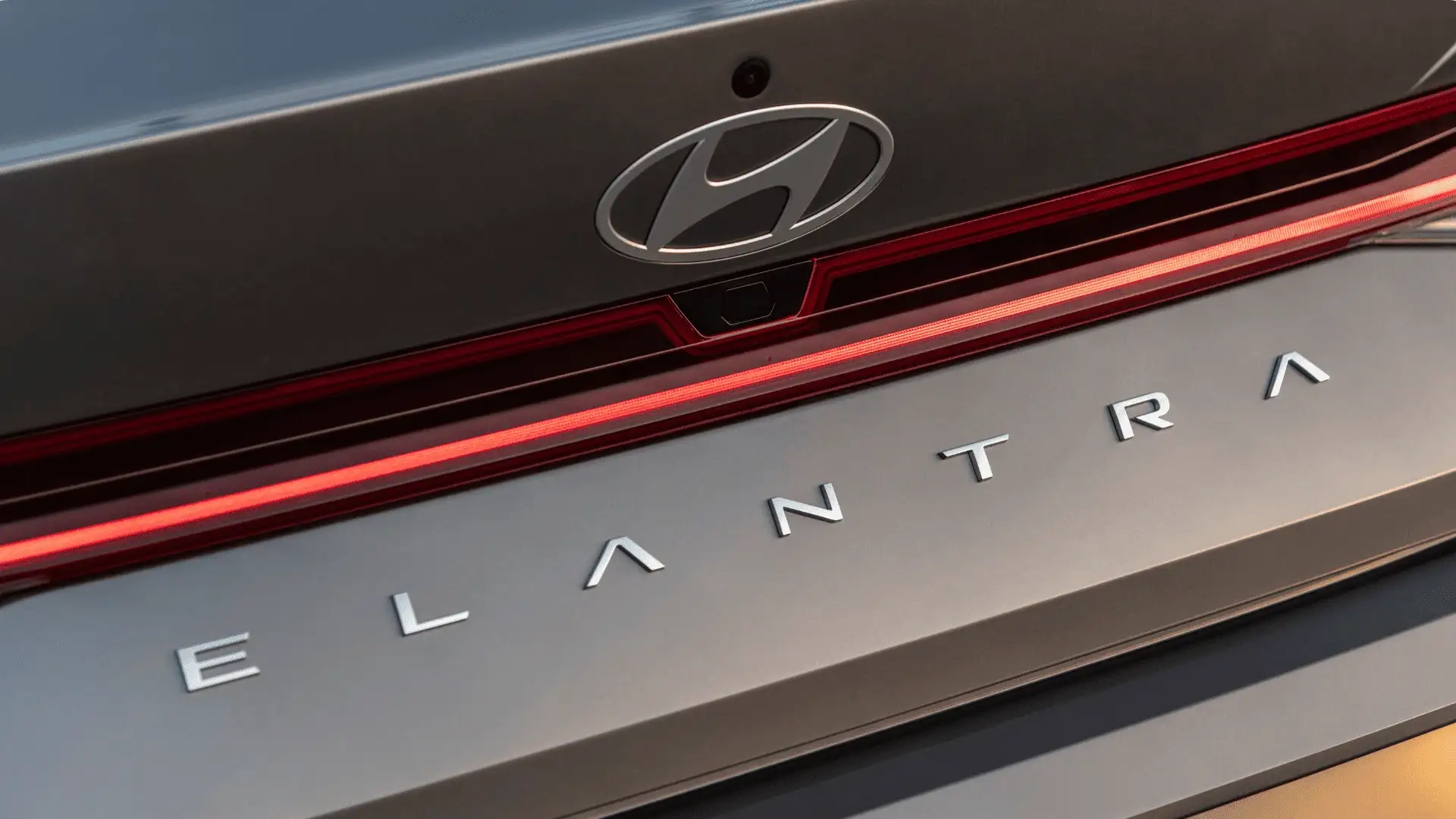 2026 Hyundai Elantra rear exterior close-up showing Hyundai badge, ELANTRA lettering, and full-width LED taillight design.