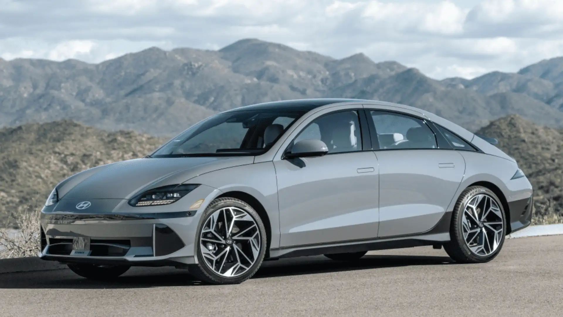 2026 Hyundai IONIQ 6 silver exterior side profile with aerodynamic body lines and alloy wheels outdoors.