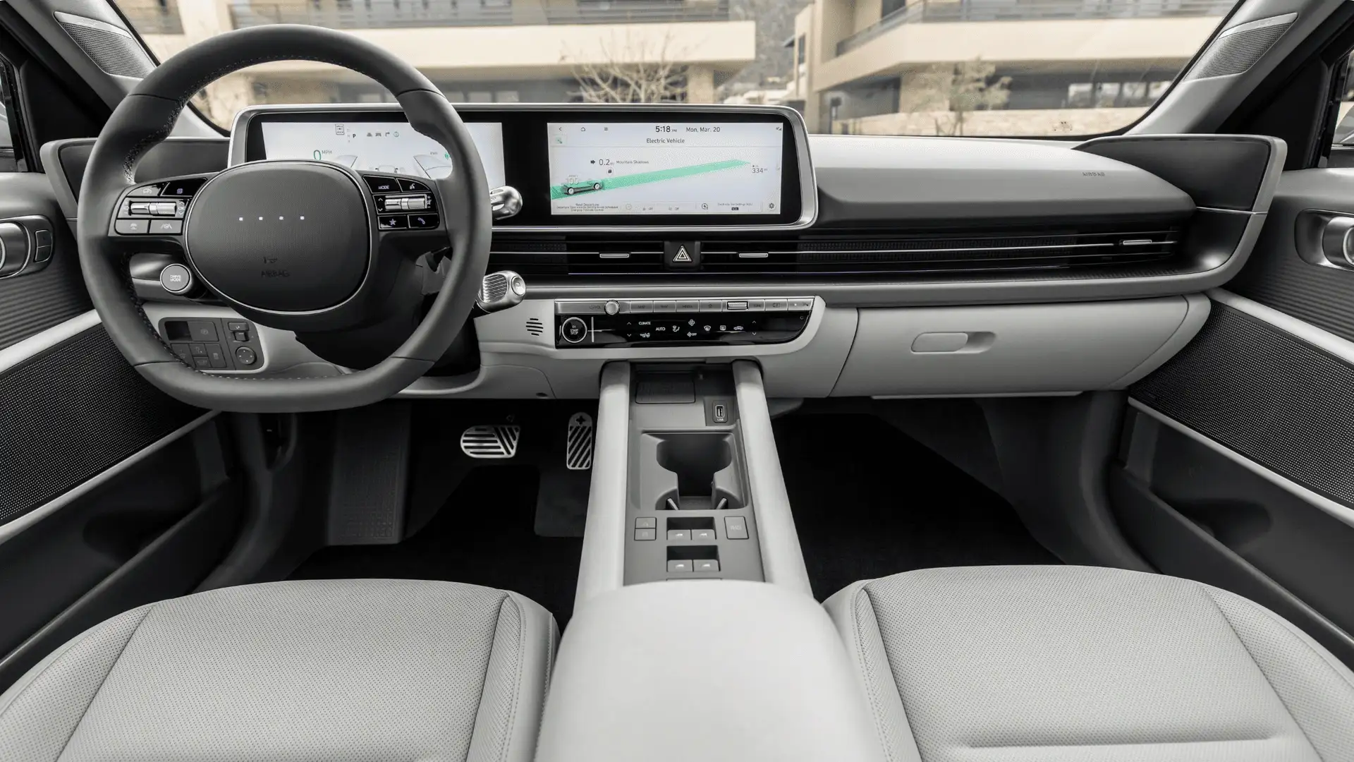 2026 Hyundai IONIQ 6 interior dashboard with dual digital displays, steering wheel, and light gray seats.