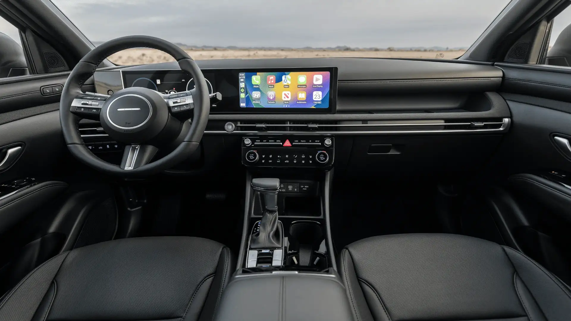 2026 Hyundai Santa Cruz interior dashboard view with widescreen display, Apple CarPlay, and modern center console.