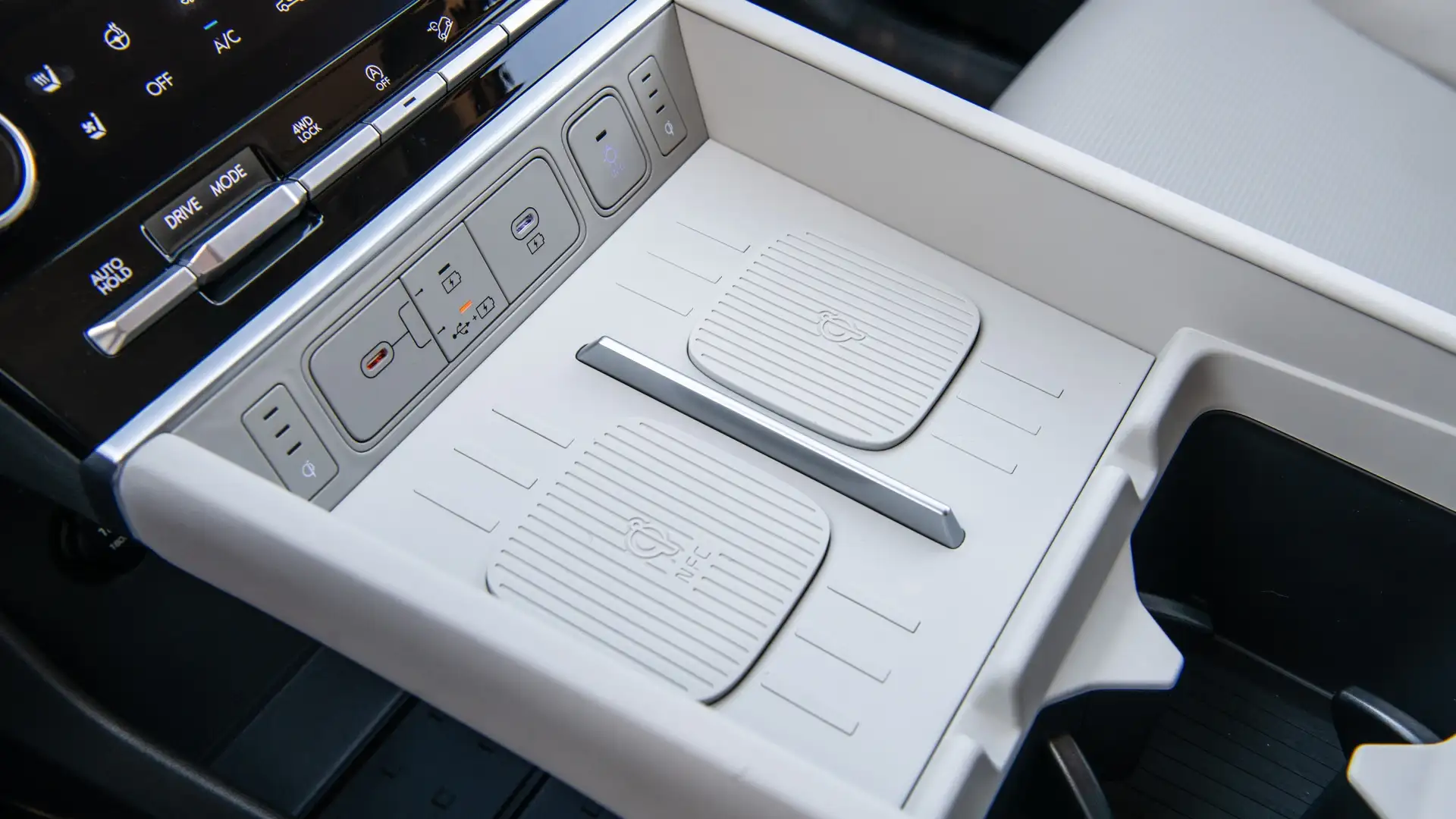 2026 Hyundai Santa Fe center console with dual wireless charging pads, USB ports, and integrated storage tray.
