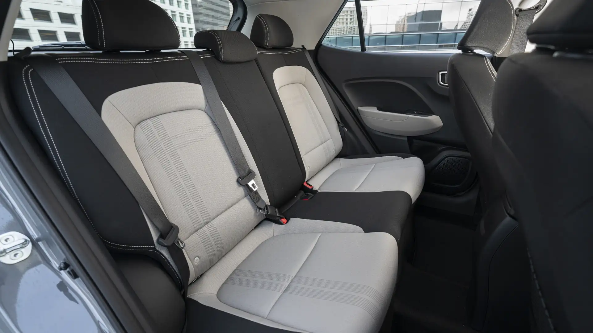 2026 Hyundai Venue rear seating with two-tone cloth upholstery, headrests, and compact second-row layout.