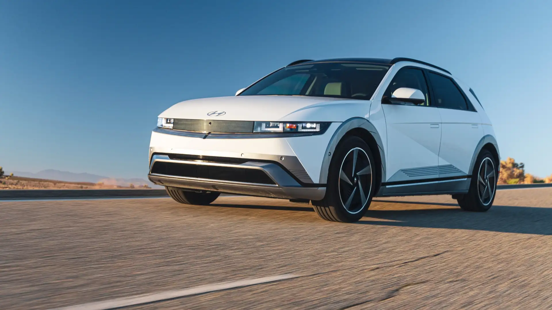 2026 Hyundai IONIQ 5 electric SUV driving on open highway showcasing aerodynamic design and EV styling.