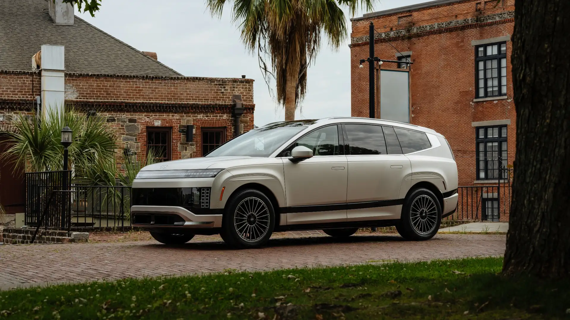 Exterior side view of the 2026 Hyundai IONIQ 9 parked in an urban setting highlighting its sleek SUV profile.