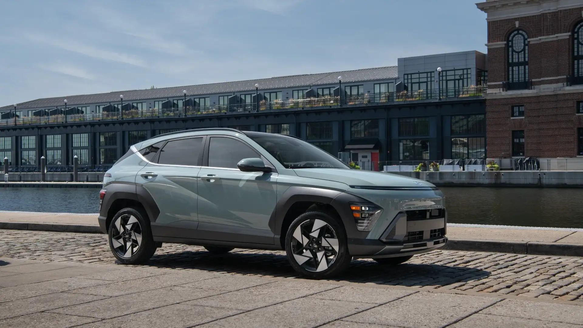 2026 Hyundai Kona compact SUV side profile parked near waterfront showing bold styling and wheel design.