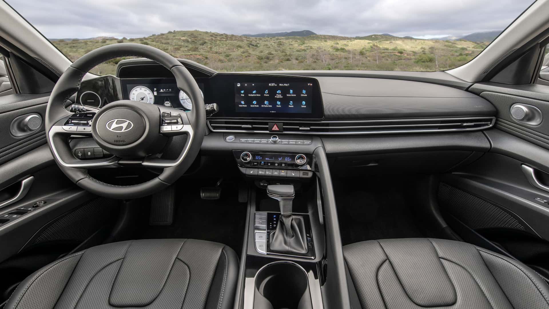 2026 Hyundai Elantra driver cockpit showing steering wheel, digital instrument cluster, wide touchscreen display, and center console controls.