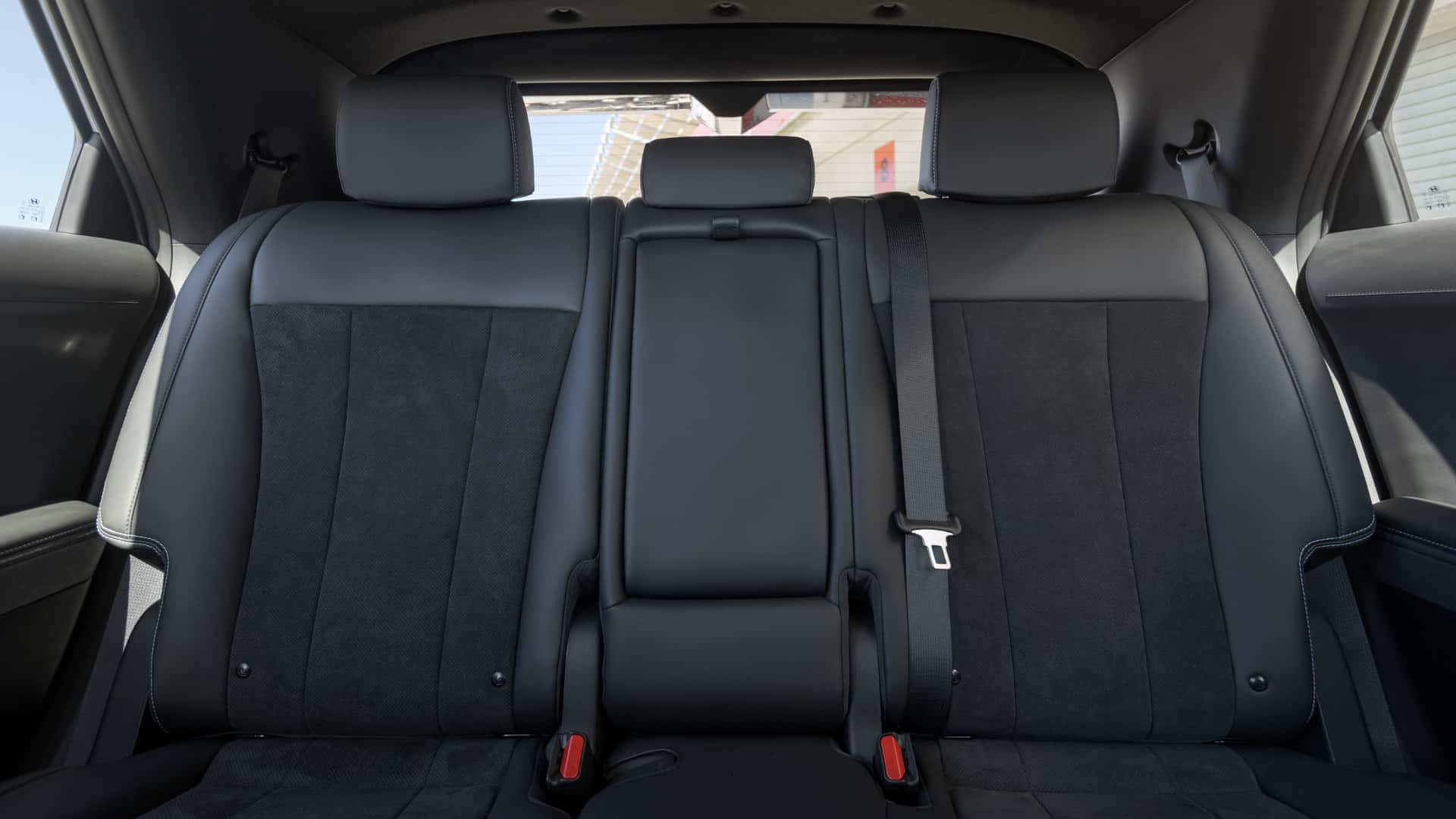 Rear seat view in a 2026 Hyundai IONIQ 5 N showing black upholstery, center armrest section, and seatbelt anchors.