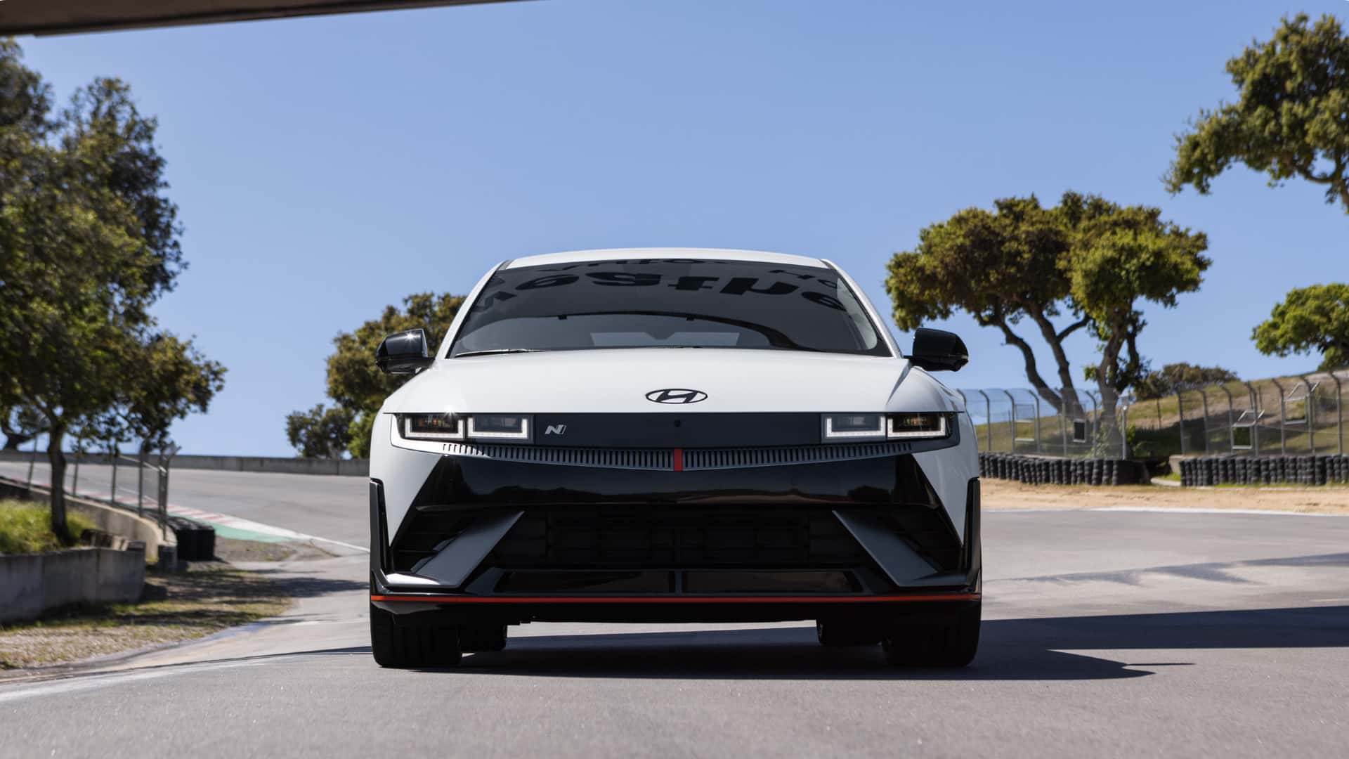 Front view of a 2026 Hyundai IONIQ 5 N on a track showing the N badge, aggressive fascia, and sporty front splitter.