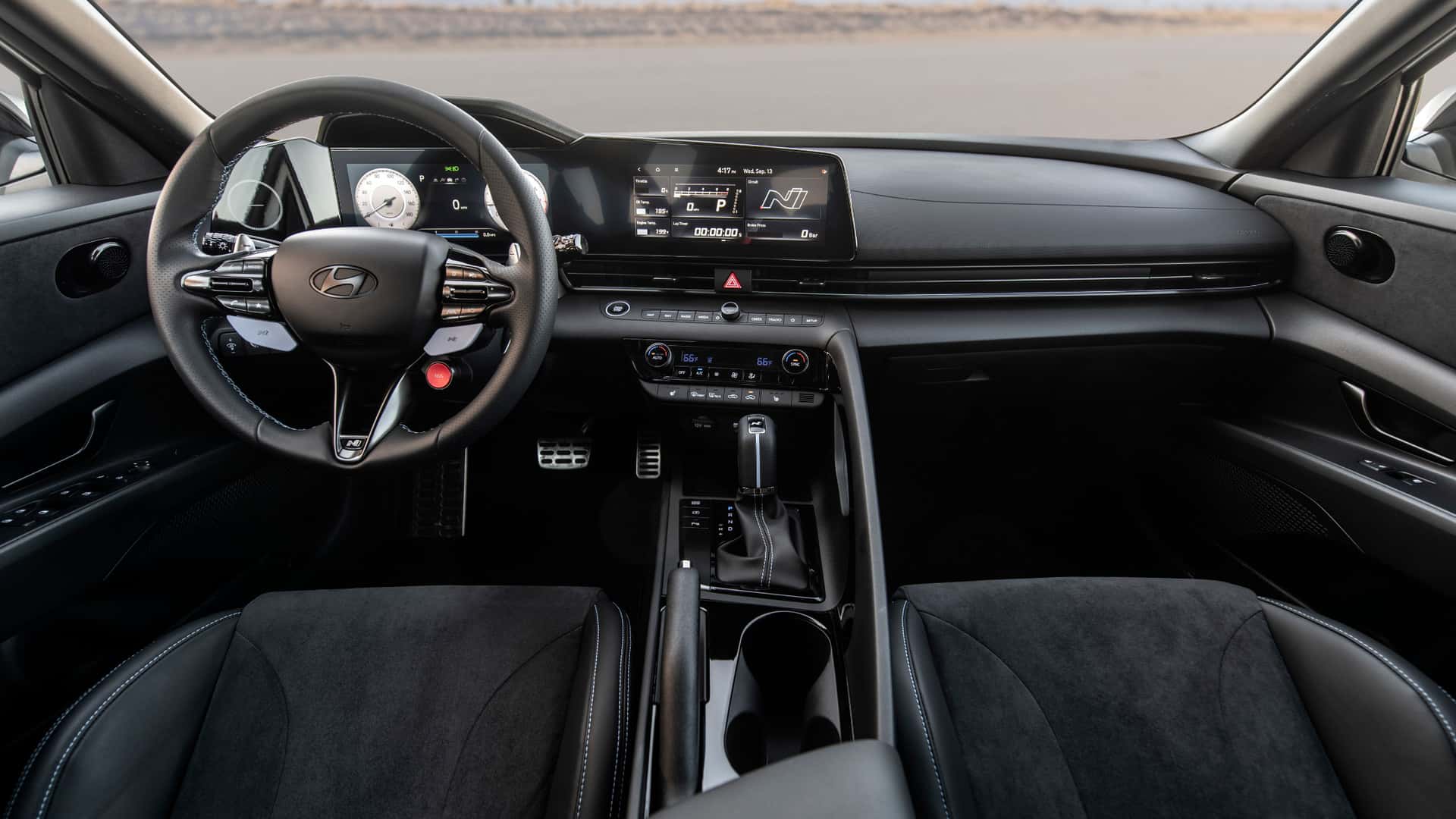 2026 Hyundai Elantra N interior with digital display, sport steering wheel, and center console.