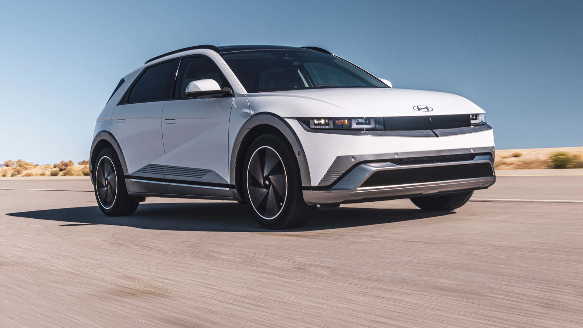 2026 Hyundai IONIQ 5 driving on an open road with a clean, modern electric SUV design.