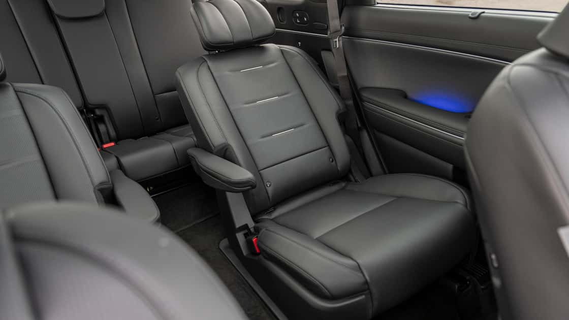 2026 Hyundai Palisade interior rear view highlighting second-row captain seats, third-row seating, and spacious cabin.