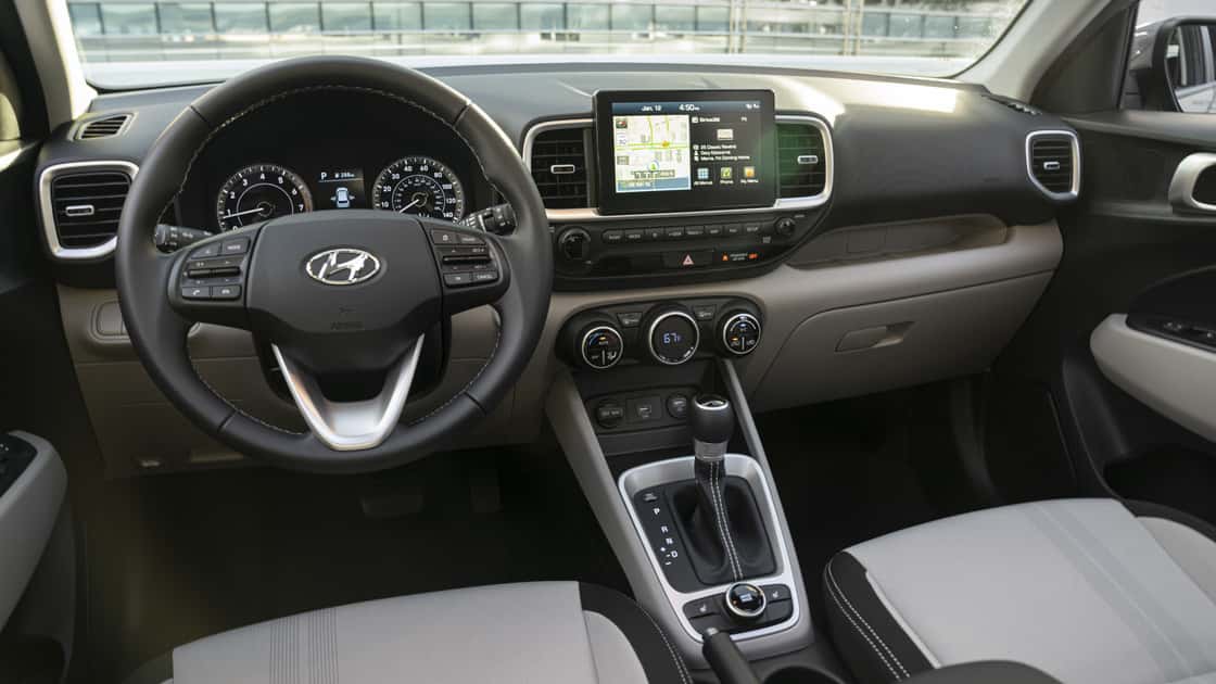 2026 Hyundai Venue interior front view showing steering wheel, dashboard, digital display, and center touchscreen with infotainment system.
