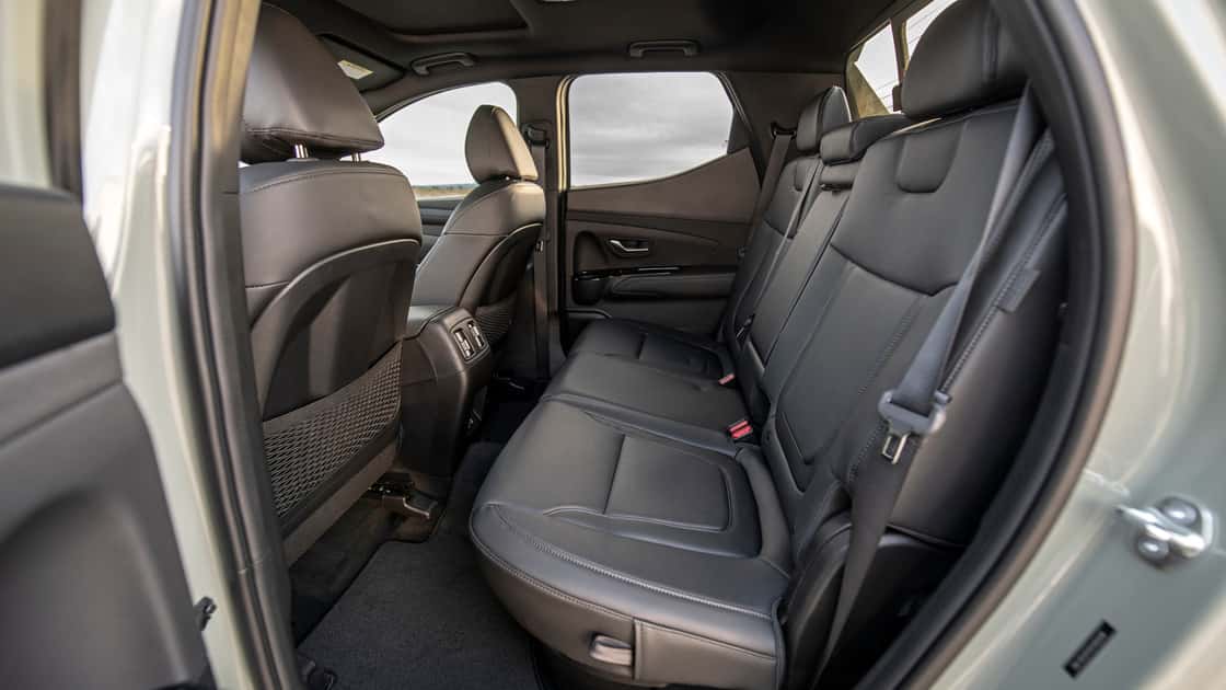 2026 Hyundai Santa Cruz rear cabin with black seating, rear climate vents, seatbelts, and spacious passenger layout.