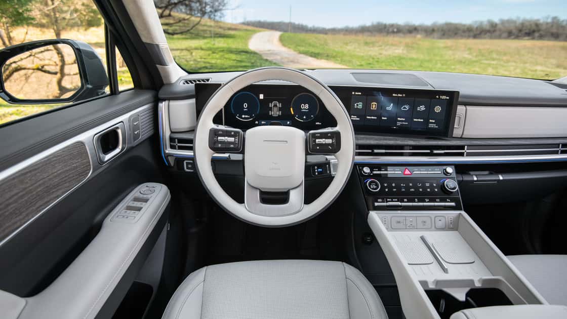 2026 Hyundai Santa Fe interior with wide digital displays, light cabin trim, steering controls, and modern dashboard.