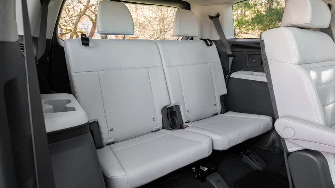 2026 Hyundai Santa Fe third-row seating with light upholstery, cupholder storage, and spacious rear cabin layout.