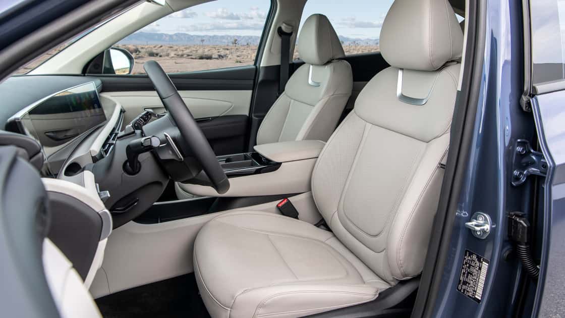 2026 Hyundai Tucson front seats with light upholstery, clean cabin design, and spacious passenger layout.