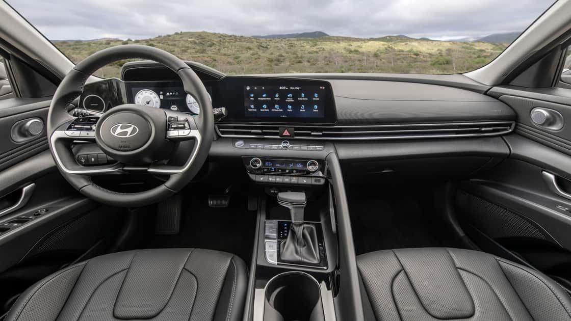 2026 Hyundai Elantra interior with touchscreen display, digital gauges, leather seats, and center console controls.